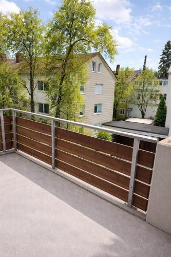 a wooden fence in front of a house at Sauna Apartment Adelina Bad Wörishofen in Bad Wörishofen
