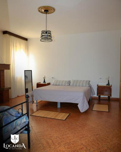 a bedroom with a white bed and a lamp at Locanda di Cornoleda in Cinto Euganeo