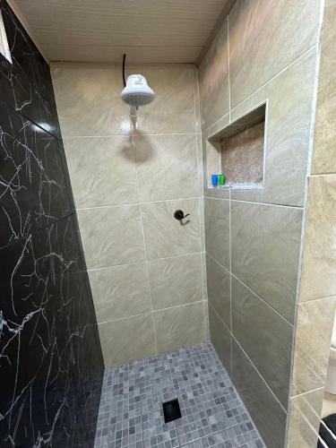 a bathroom with a shower with a tiled shower at Blue Dream in Los Altos de Cerro Azul