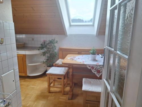 a bathroom with a table and a sink and a tub at Apartmaji Marinka Hodnik in Bohinj