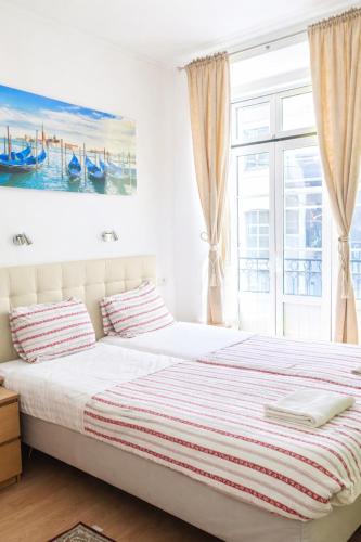 a bedroom with a bed and a window at Baixa GuestHouse in Lisbon