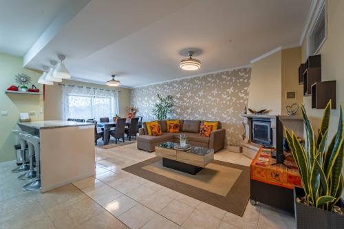 a living room with a couch and a table at Cozy and Quiet Spacious Flat in Oliveira do Douro