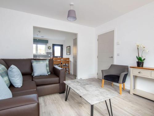 a living room with a couch and a table at Oakwood in Aviemore