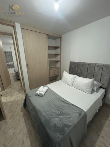 a bedroom with a bed with two slippers on it at KD Prime Suite Al Norte de la Ciudad in Valledupar