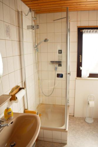 a bathroom with a shower and a sink at Gästehaus Heuchert in Meersburg