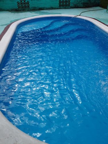 a swimming pool with blue water in it at Cabañas Las Moras in Candelaria