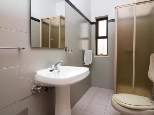 a bathroom with a sink and a toilet and a mirror at Villa Bel Mar by Stay ici in Albufeira
