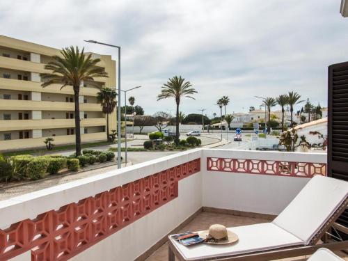 a balcony with a view of a street and palm trees at Villa Bel Mar by Stay ici in Albufeira
