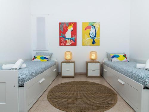 two beds in a room with two lamps at Villa Bel Mar by Stay ici in Albufeira