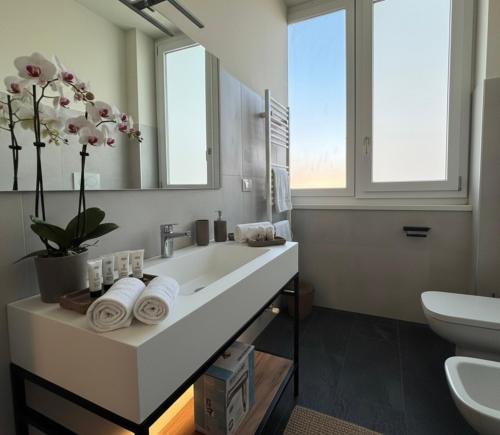 a bathroom with a sink and a toilet and a mirror at SPACE101 City Apartment & Studio in Limito di Pioltello
