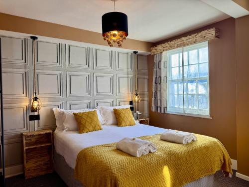 a bedroom with a bed with two towels on it at The Crescent Guest House in York