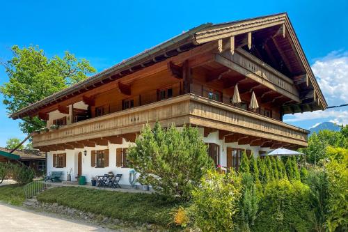 a large wooden house with a roof at Bergliebe in Schleching