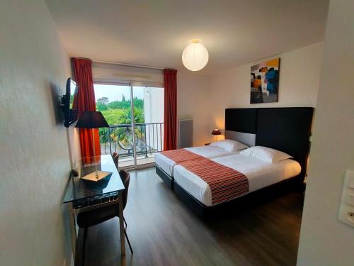 a hotel room with a bed and a window at Adonis La Baule in La Baule