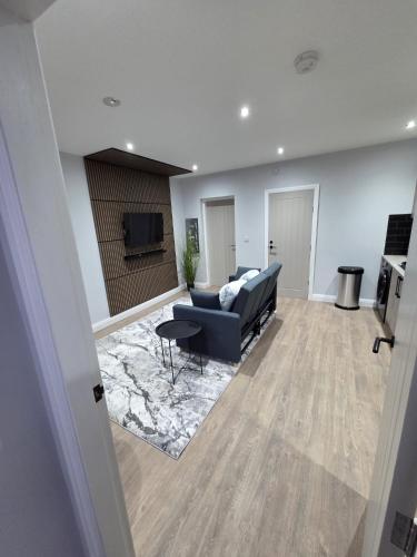 a living room with a couch and a tv at Easy access to manchester airport &city centre in Manchester