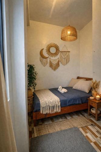a bedroom with a bed and a mirror on the wall at Matropica CoWorking Hostel in General Luna