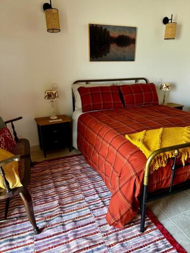 a bedroom with a bed and a table and a chair at Casa da Curva in Mendiga