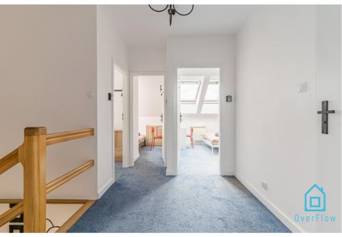 a hallway with white walls and a cross on the wall at Sunlight Room - 15 min to Old Town Gdansk in Gdańsk