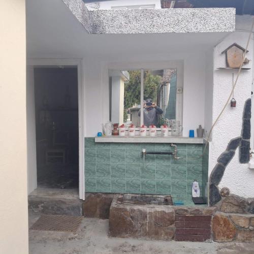 a person taking a picture of a mirror in a house at Самостоятелна къща за гости Трояна in Troyan