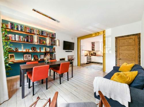 a living room with a blue couch and a table at Designer Flat in Bethnal Green in London