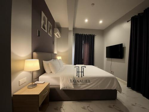 a hotel room with a bed with a pillow on it at Tainaliel Homes and Properties in Mama