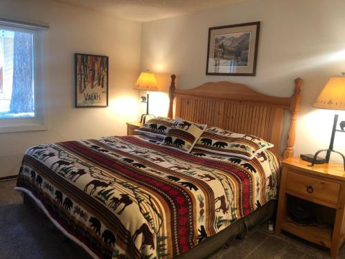 a bedroom with a large bed with a colorful blanket at Mammoth Creek Unit 15 in Mammoth Lakes