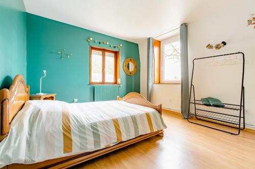 a bedroom with a large bed and a mirror at Chez Joséphine et Pierre in Cassel