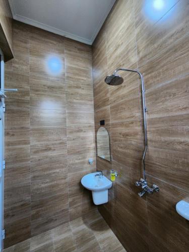 a bathroom with a sink and a shower at Karibu Haven Apartments in Arusha
