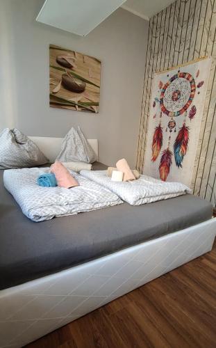 a bed with two pillows on it in a room at TRZY SOWY noclegi Bytom 24h meldunek samodzielny wygodnelokumpl in Bytom