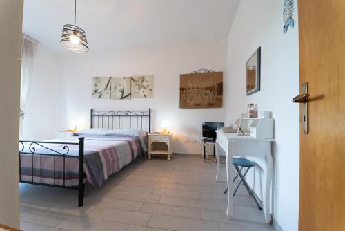 a bedroom with a bed and a desk in a room at AZZURRO LIDO ADRIANO VISTA MARE in Lido Adriano