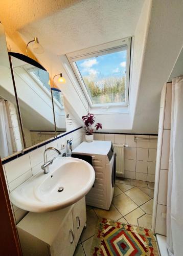 a bathroom with a sink and a window at Gästezimmer Traisen in Traisen