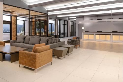 a living room with a couch and chairs and a projection screen at William Tell Hotel MOD Collection by Sonesta in Countryside
