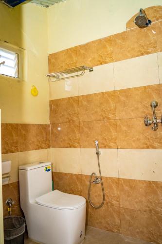 a bathroom with a toilet and a shower at Chautari Hotel & Restaurant in Astam