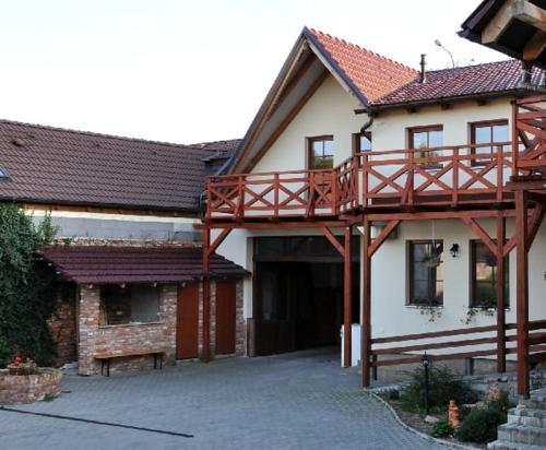 a house with a wooden walkway on top of it at Penzion Zacha se sklípkem in Vracov