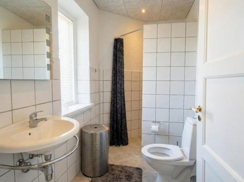 a bathroom with a sink and a toilet at Penthouse - 3BR - Esbjerg Island in Esbjerg