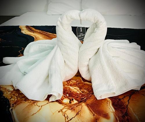 a pile of white towels on a bed at BeB VillaReal in Balvano