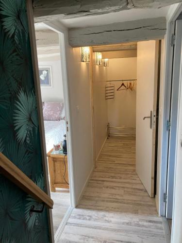 a hallway leading to a bedroom with a bed at La suite de L'Eau qui dort in Pleslin-Trigavou