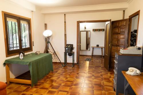 a room with a table with a green table cloth at El Cerro del Pinar in Oropesa