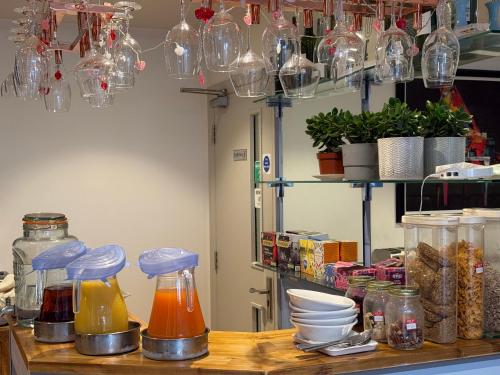 a kitchen counter with jars and dishes on a table at Oxford Guest House in Oxford