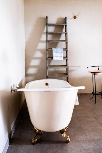 a white bath tub in a room with a ladder at Tre Cercole - Eco Resort in San Marco in Lamis