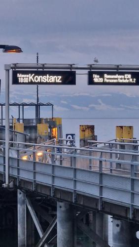 a train on a bridge with a sign on it at Lian am See in Friedrichshafen