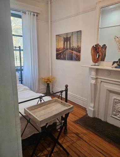 a room with a table and a fireplace at Harlem Brownstone in New York
