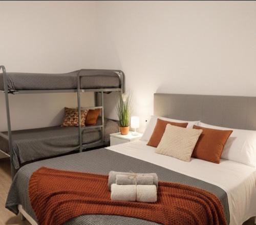a bedroom with a bed with two bunk beds at Appartamento estivo PONENTE - Misano Adriatico -RN- in Misano Adriatico