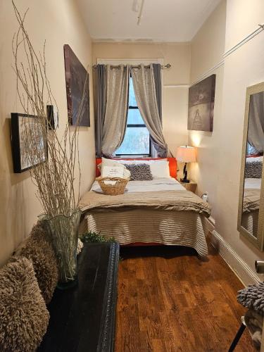 a bedroom with a bed and a window at Harlem Brownstone in New York