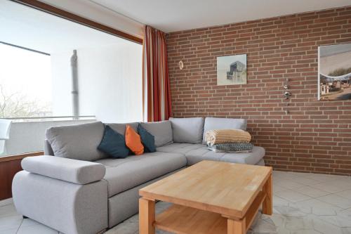 a living room with a couch and a coffee table at FeWo Lange - Whg 48 in Kellenhusen