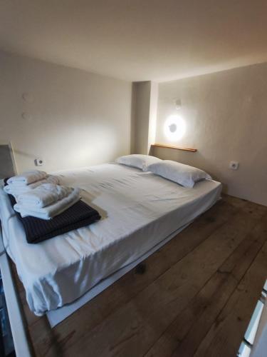 a bedroom with a large bed with white sheets and pillows at Apartment Studio 6 in Mytilene