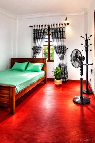 a bedroom with a bed and a red carpet at Wilpattu Gagana guest in Nochchiyagama