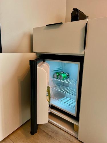 an empty refrigerator with its door open in a room at 2 Houseboat Suites Amsterdam Prinsengracht in Amsterdam