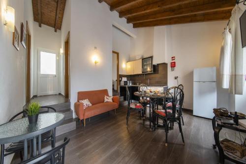 a living room with a couch and a table with chairs at C14 - Casa da Luz in Luz