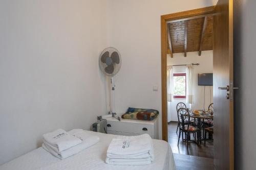 a bedroom with a bed with two towels on it at C14 - Casa da Luz in Luz