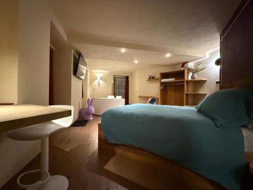 a bedroom with a bed and a desk in it at Lo Berio Morgex in Morgex